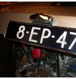 Chrome metal license plate light, example mounted